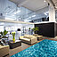 Bürolounge mit Sofas, Pflanzen und einem großen Teppich in Wasseroptik.